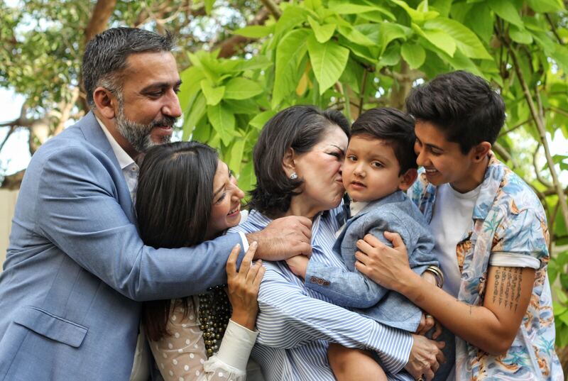 Family of four in white outfits.