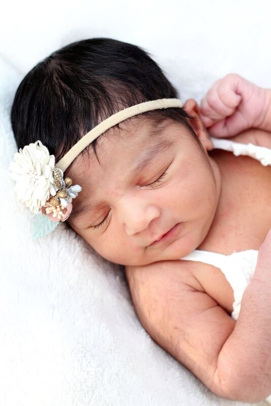 Newborn sleeping in cream.